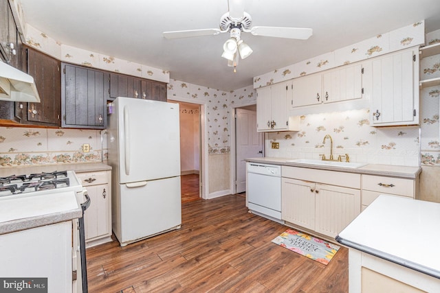 kitchen with white cabinetry, sink, ceiling fan, dark wood-type flooring, and white appliances