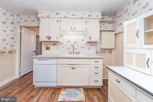 kitchen with light countertops, dishwasher, a sink, and wallpapered walls