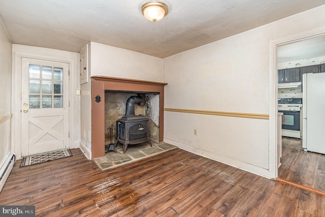 unfurnished living room with dark wood-style flooring and a wood stove