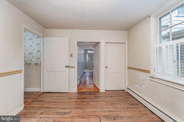 interior space with hardwood / wood-style floors and baseboard heating