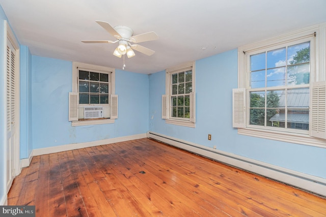 unfurnished room featuring a baseboard radiator, plenty of natural light, cooling unit, ceiling fan, and hardwood / wood-style floors