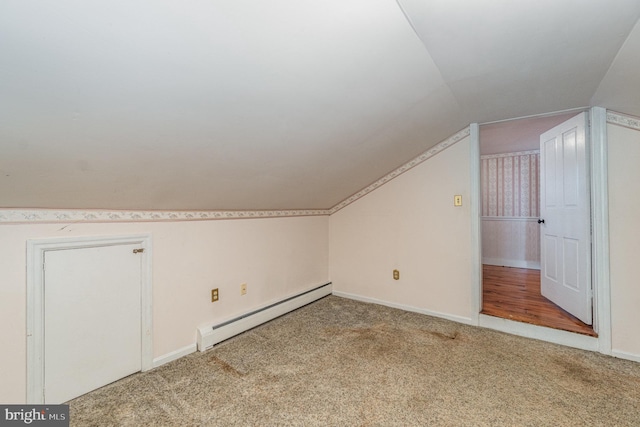 additional living space featuring a baseboard radiator, lofted ceiling, and carpet floors