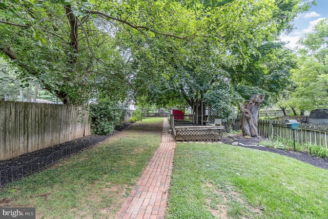 view of yard featuring a deck with water view