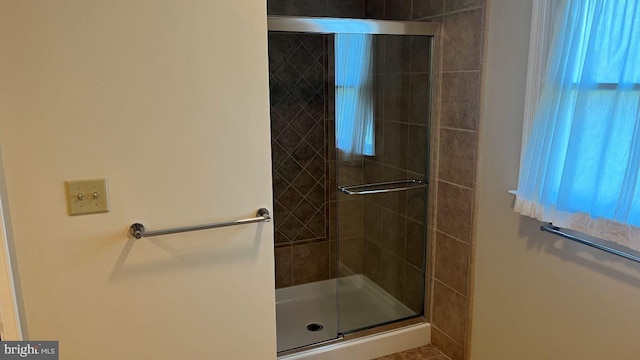 bathroom with a shower with shower door