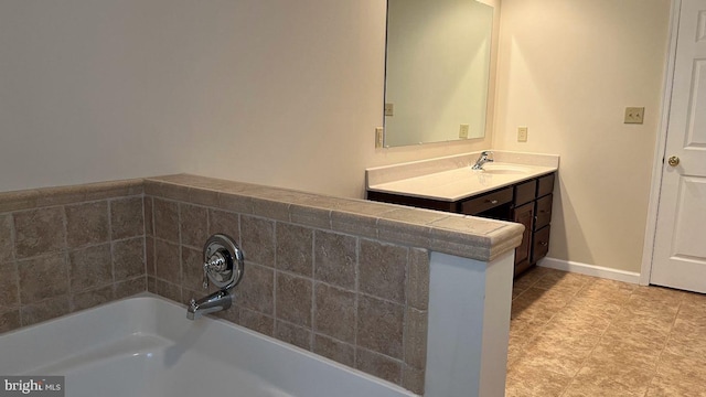 bathroom featuring a bath and vanity