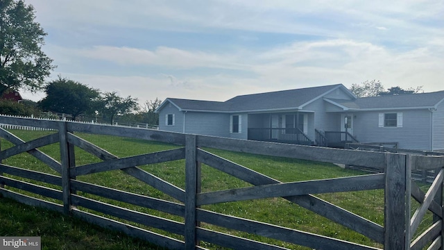 view of gate with a yard