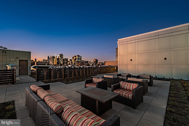 patio terrace at dusk featuring outdoor lounge area