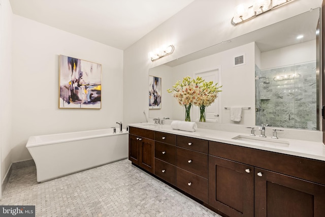 bathroom with vanity and separate shower and tub