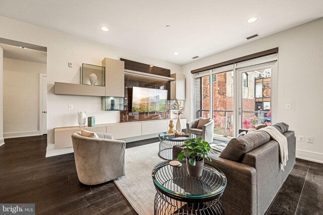 living room with dark hardwood / wood-style flooring