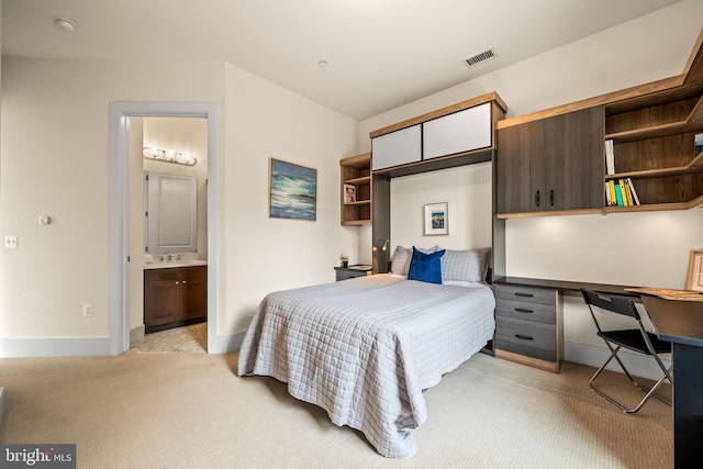 bedroom with light colored carpet, built in desk, sink, and a closet