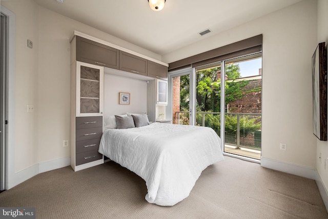 bedroom with carpet floors and access to outside