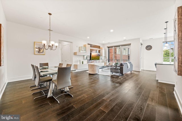 dining area with an inviting chandelier and dark hardwood / wood-style flooring