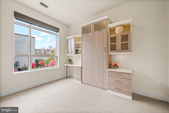 unfurnished bedroom featuring light colored carpet