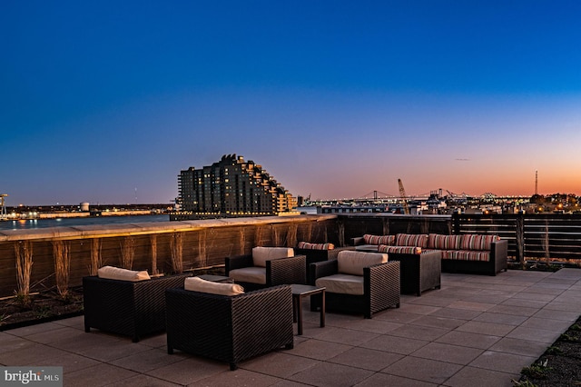 patio terrace at dusk featuring an outdoor living space