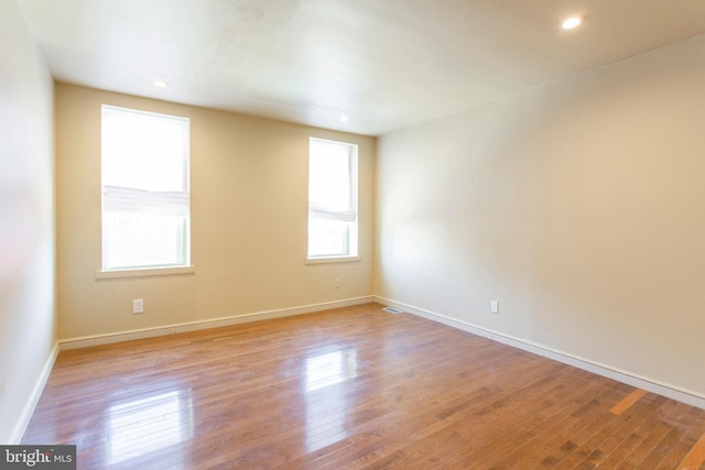 empty room with recessed lighting, baseboards, and light wood finished floors