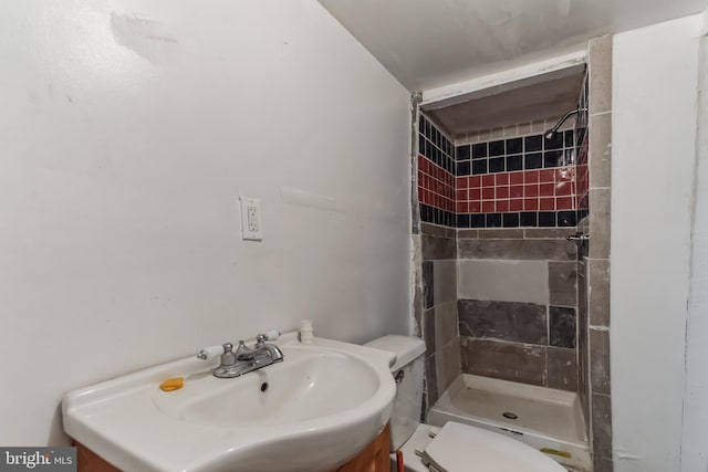 bathroom featuring a stall shower, vanity, and toilet