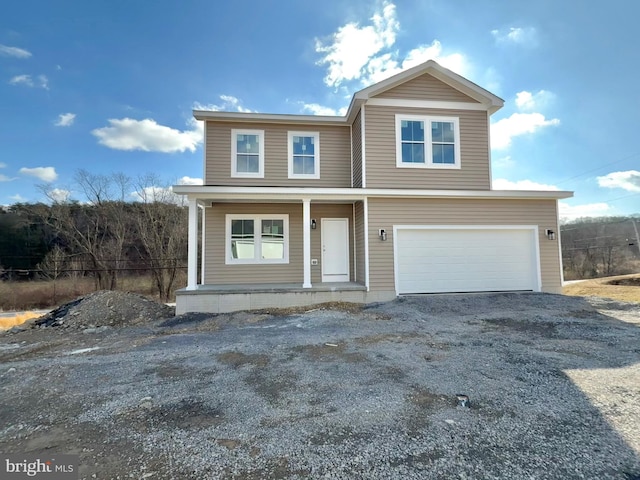 view of front of property featuring a garage and a porch