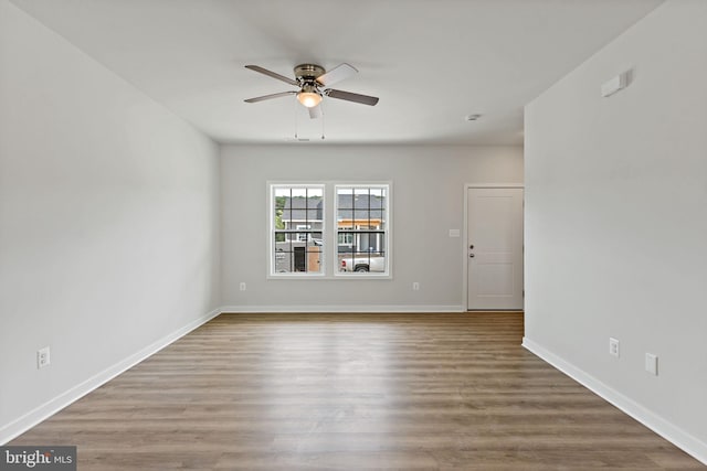 empty room with hardwood / wood-style floors and ceiling fan