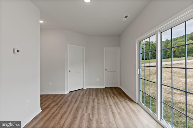 spare room featuring light hardwood / wood-style floors