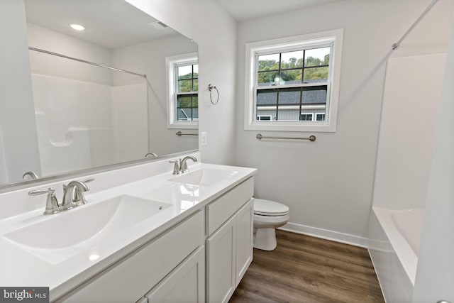 bathroom with vanity, hardwood / wood-style floors, and toilet