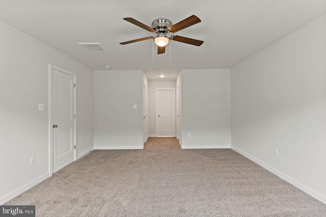 carpeted spare room with ceiling fan