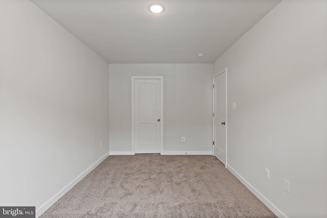 unfurnished room with light carpet