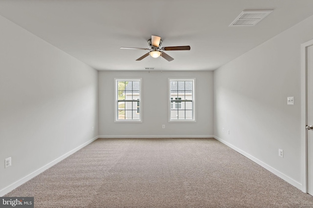 carpeted spare room featuring ceiling fan