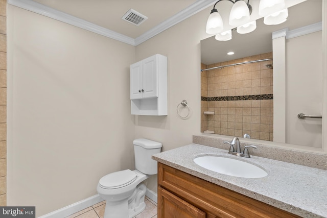 bathroom featuring vanity, crown molding, tiled shower, tile patterned flooring, and toilet