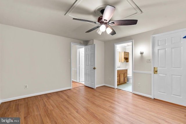 unfurnished bedroom with ensuite bathroom, ceiling fan, and light hardwood / wood-style floors