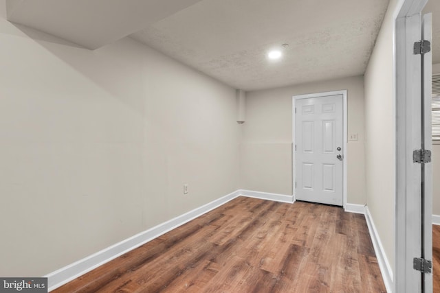 entryway featuring hardwood / wood-style floors and a textured ceiling