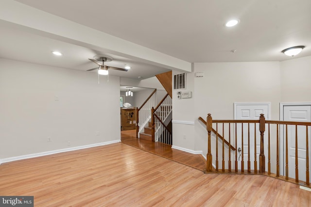 spare room with ceiling fan and light wood-type flooring