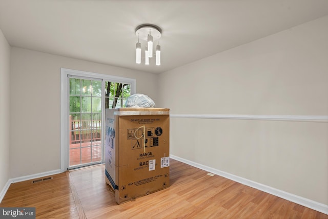 interior space featuring light hardwood / wood-style floors and a notable chandelier