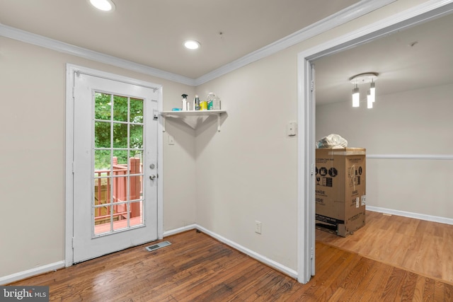 doorway to outside with crown molding and hardwood / wood-style floors