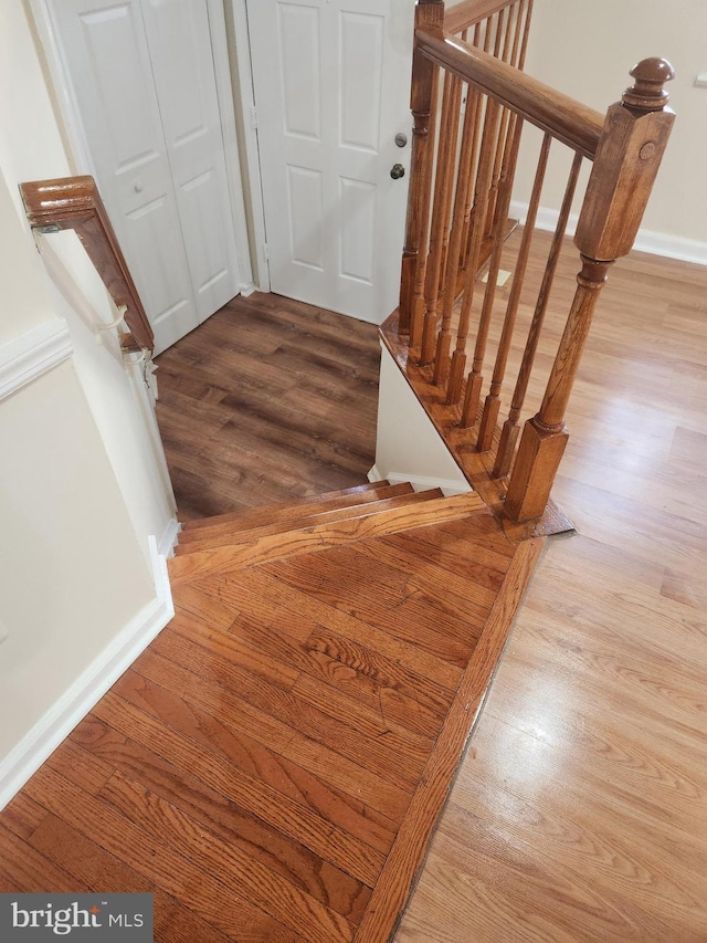 stairs with hardwood / wood-style floors