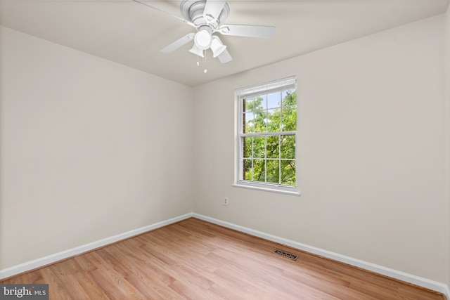 spare room with ceiling fan and light wood-type flooring