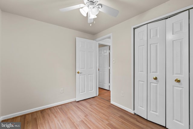 unfurnished bedroom with ceiling fan, a closet, and light hardwood / wood-style flooring