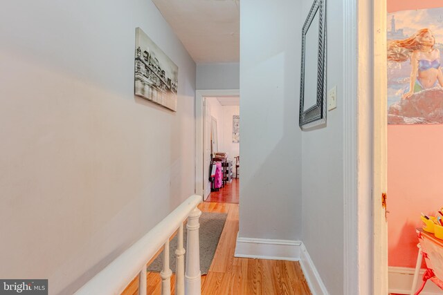 corridor with light hardwood / wood-style flooring