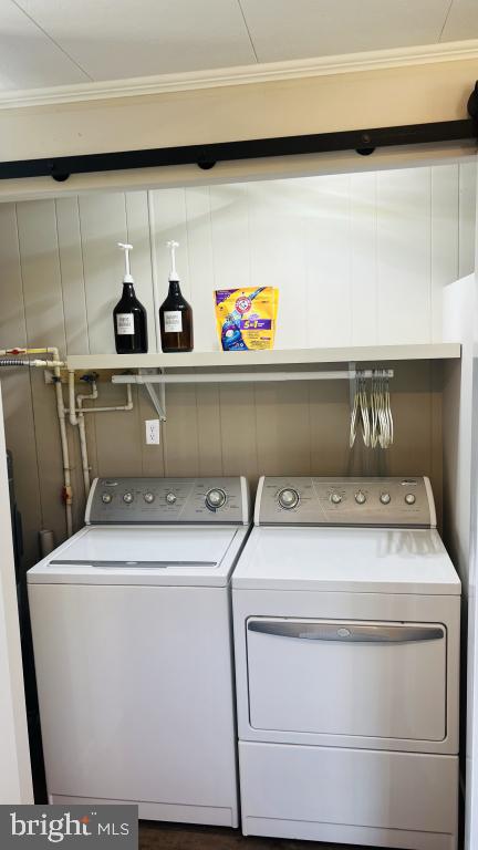 laundry area featuring separate washer and dryer and crown molding