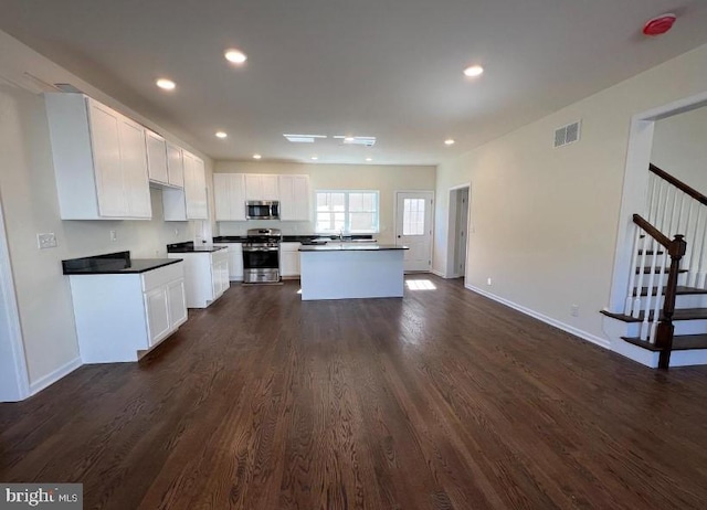 kitchen featuring visible vents, dark wood finished floors, recessed lighting, stainless steel appliances, and white cabinets