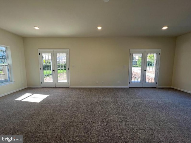 unfurnished room featuring a wealth of natural light, french doors, and carpet