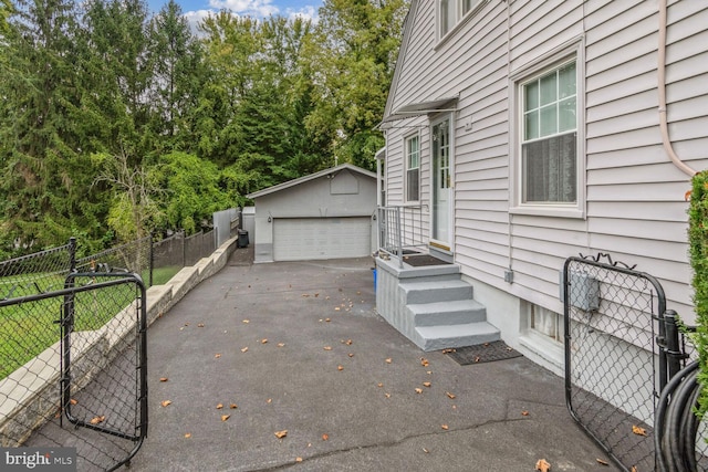 view of side of home featuring an outbuilding and a garage