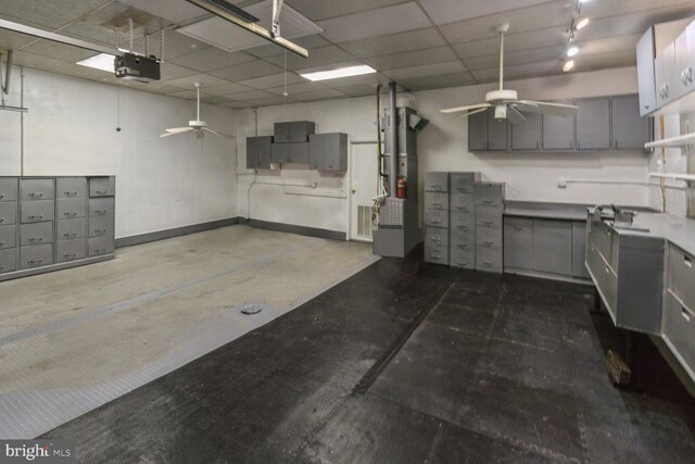 garage with a garage door opener and ceiling fan