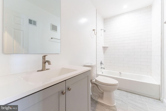 full bathroom with vanity, toilet, and tiled shower / bath