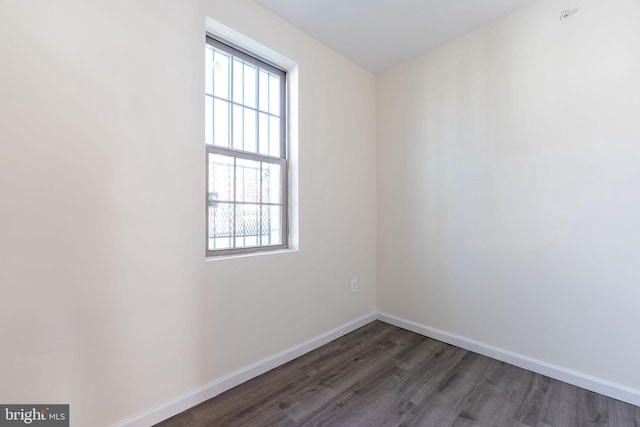 spare room with dark hardwood / wood-style flooring