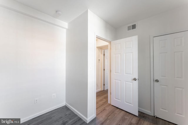 hallway featuring dark wood-type flooring