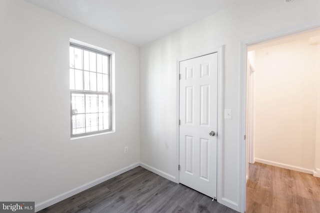 unfurnished bedroom with hardwood / wood-style flooring