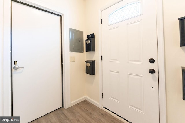 entryway with light wood-type flooring and electric panel