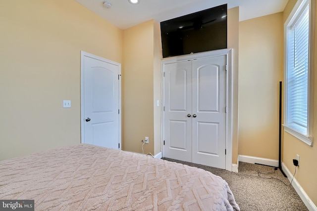 unfurnished bedroom with a closet and carpet flooring