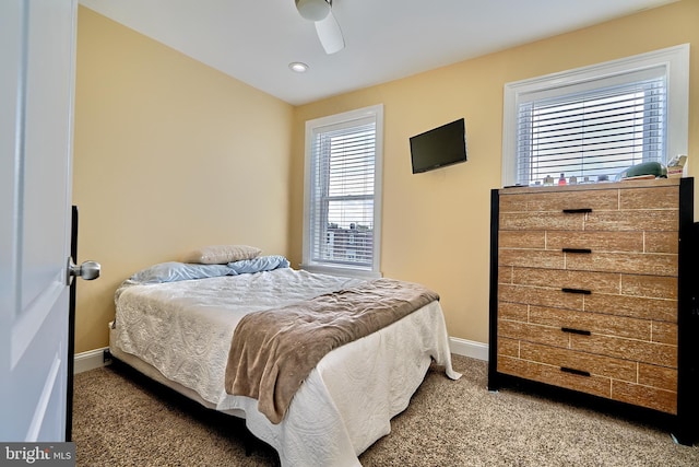 bedroom featuring ceiling fan and carpet