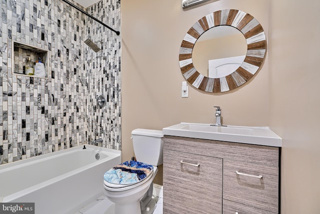 full bathroom featuring tiled shower / bath, vanity, and toilet